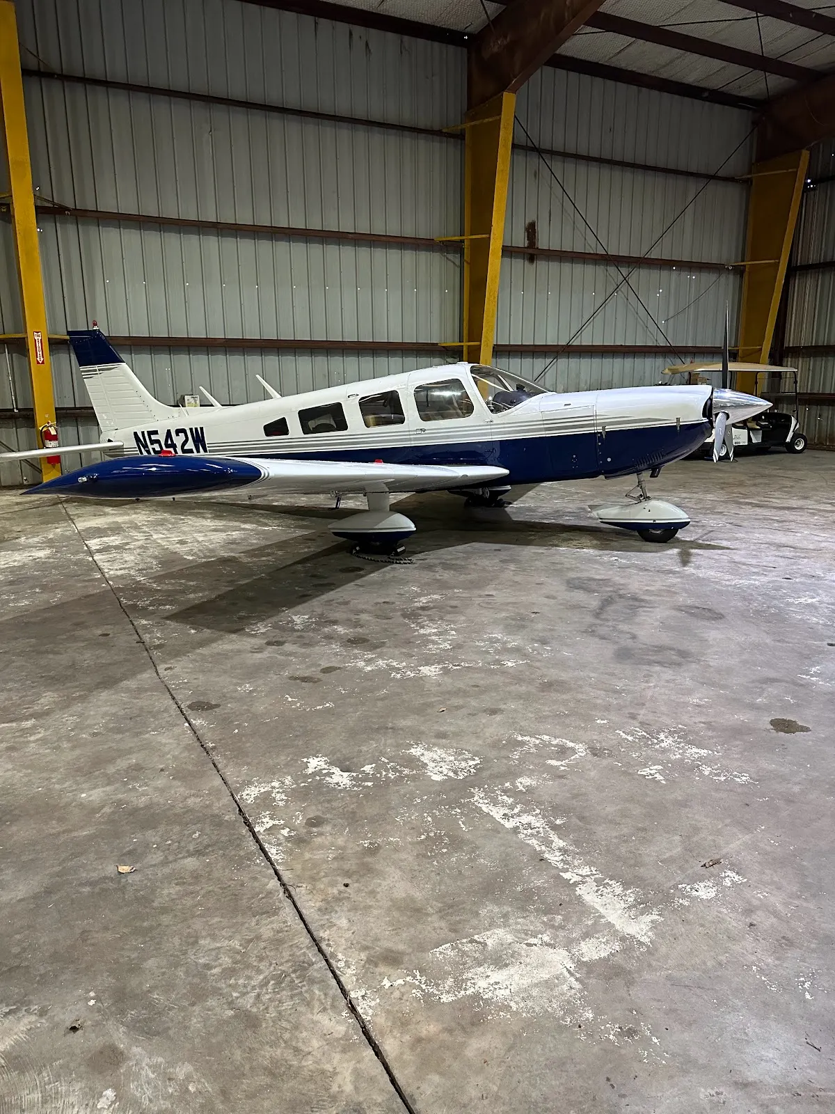 Side view of N542W in the hangar