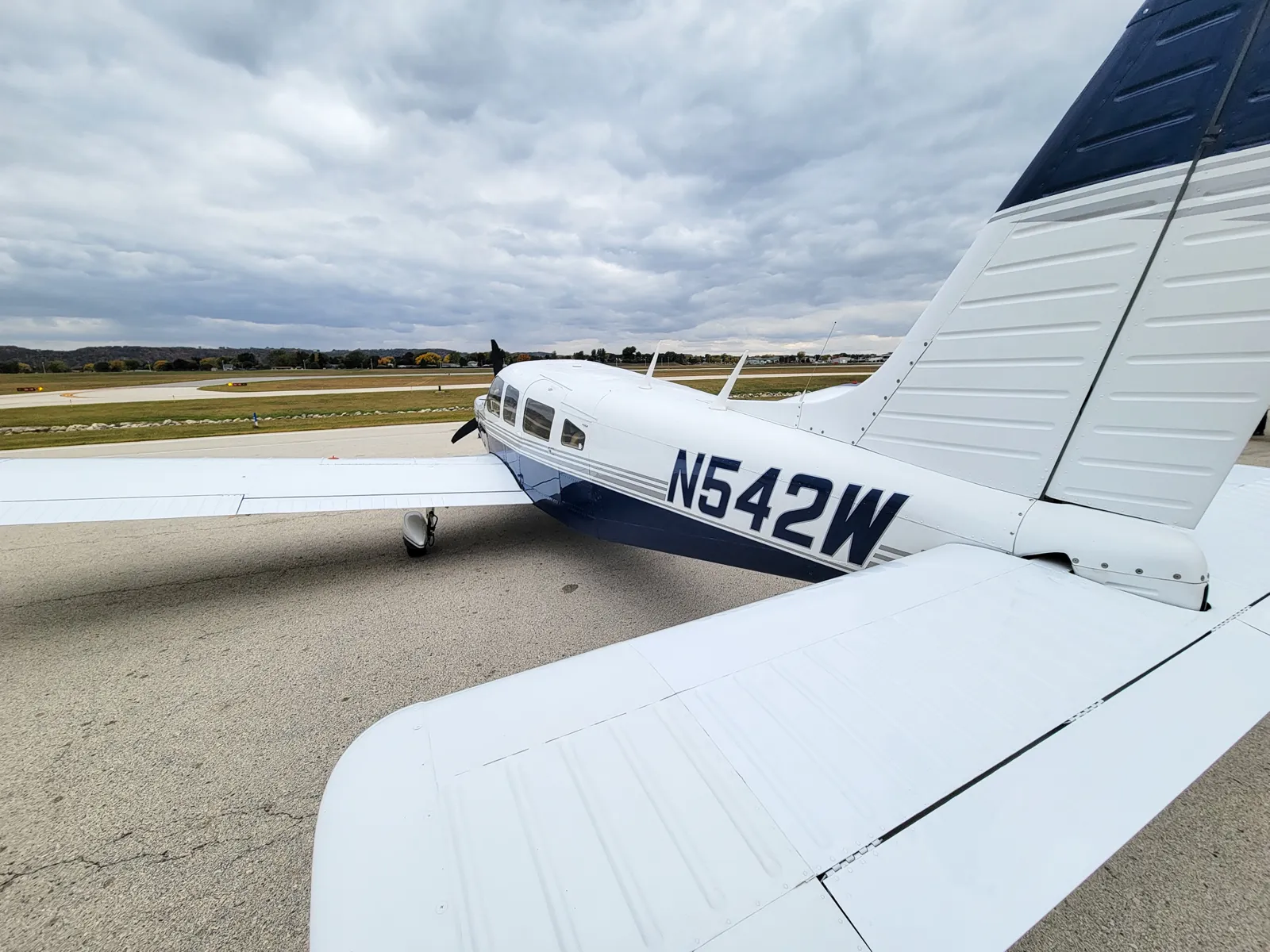 Tail and stabilator of N542W with the airfield behind